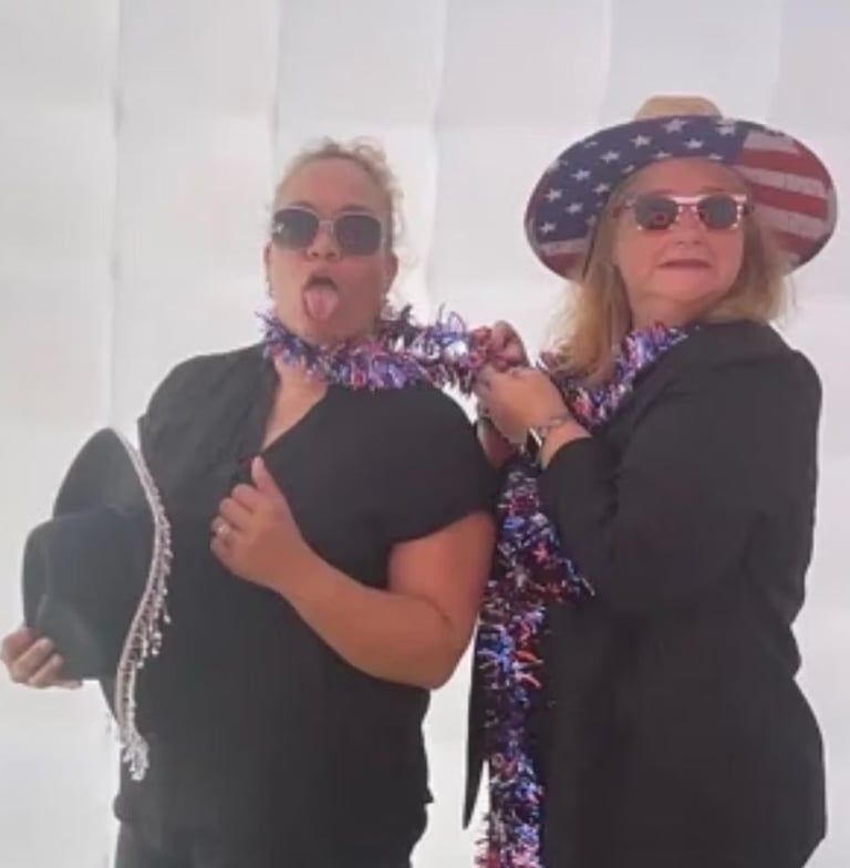 two women in patriotic attire posing for a photo
