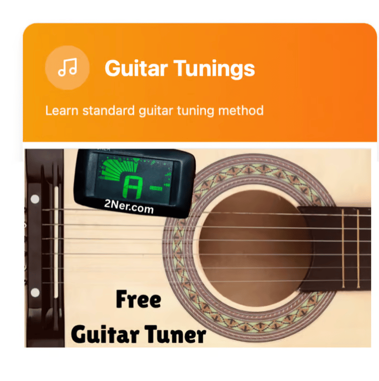 Digital clip-on guitar tuner attached to an acoustic guitar for standard tuning.