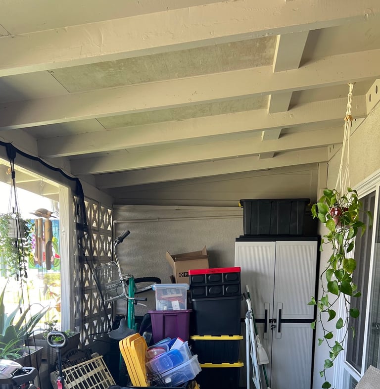 Before staging: a cluttered patio with a table and chairs and a table