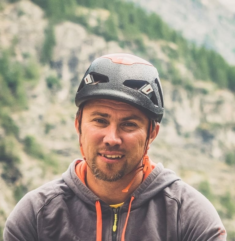 a man in a helmet on a mountain