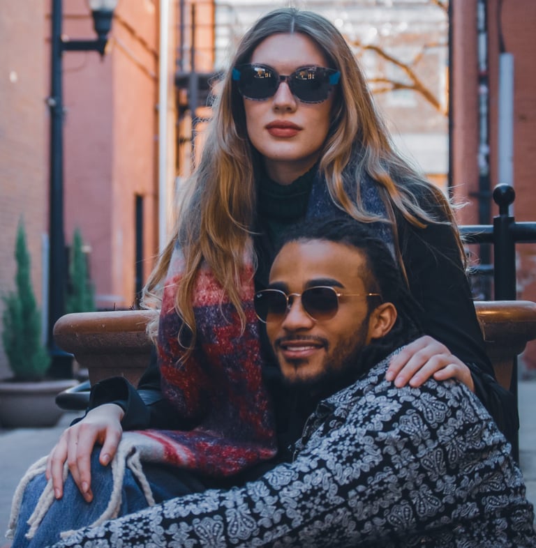 Man and woman modeling stylish sunglasses in downtown Fort Collins