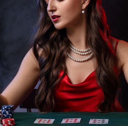 a woman in a red dress playing cards
