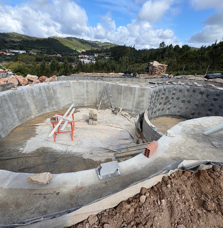 Natural pool build in progress with curved concrete walls and steel rebar — Aqua Vitae construction