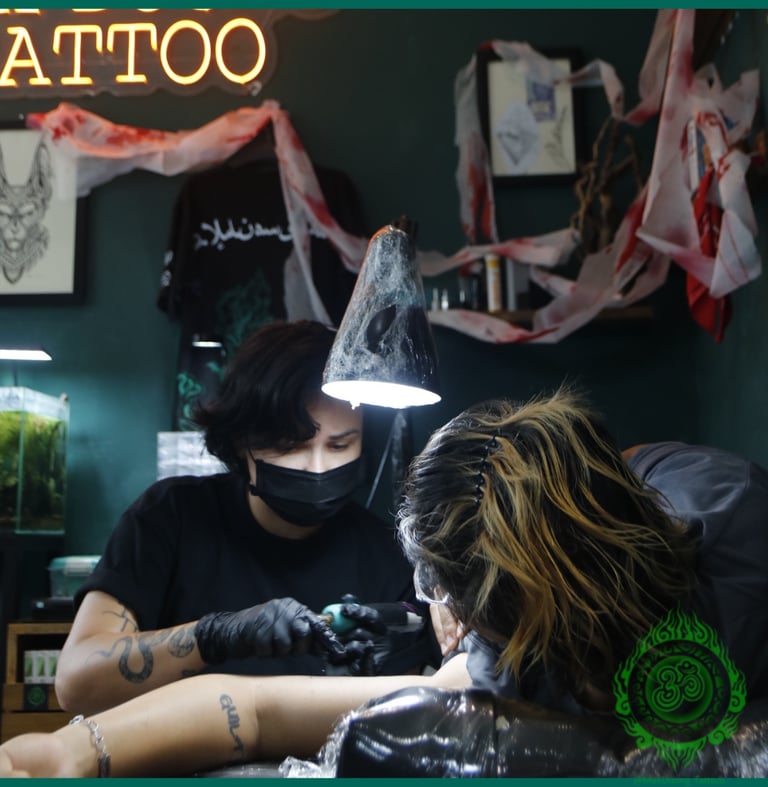 tattoo artist are tattooing