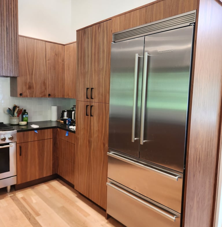 stainless steel refrigerator and walnut cabinets