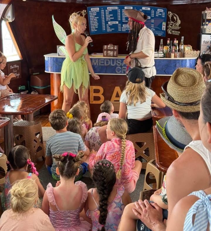 Fairy and pirate entertaining children on a family boat tour in Cyprus