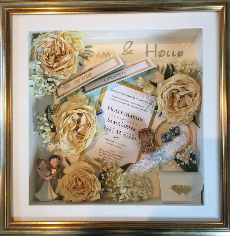 a Memory Box frame featuring wedding keepsakes and flowers
