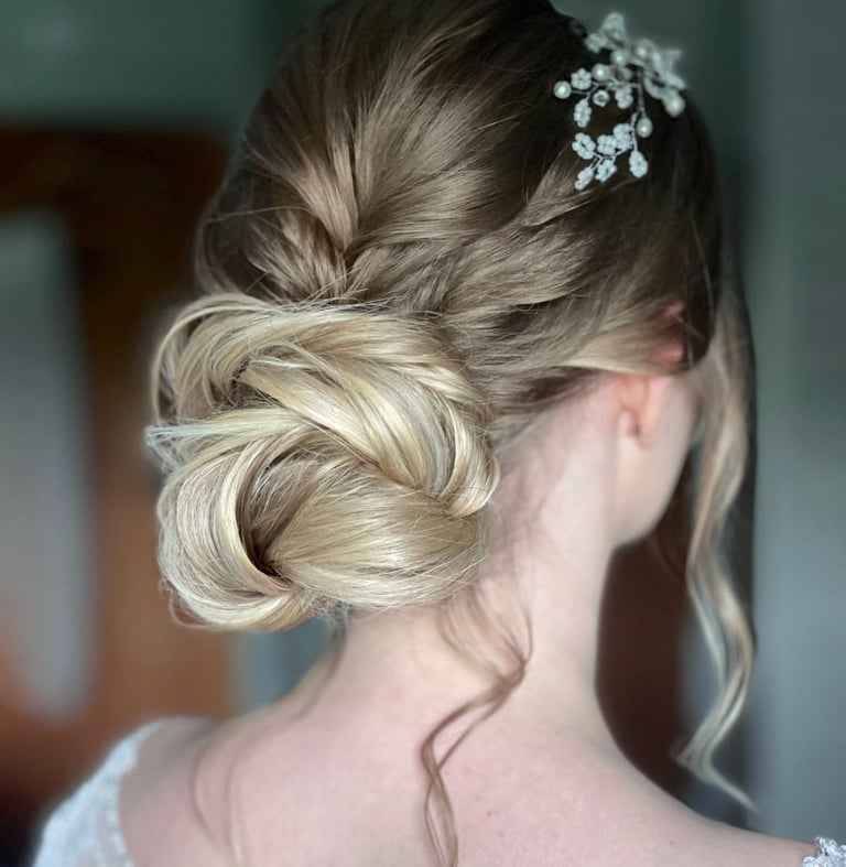 a woman with wedding hair with a flower in her hair