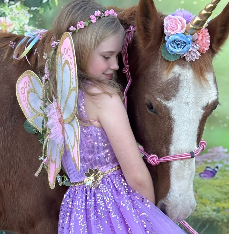 A fairy princess cuddles Snickers, the magical unicorn