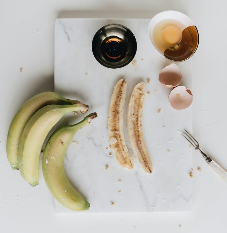 a cutting board with bananas and eggs on it