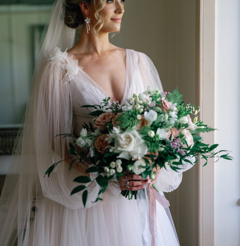 a bride in a wedding dress holding a bouquet