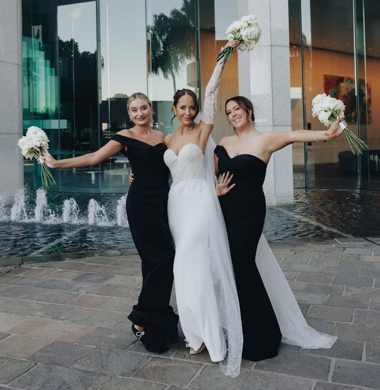 a bride and bridesmaid posing for a photo