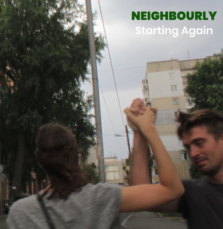 a man and a woman holding hands in the air in a hopeful way, smiling against an overcast backdrop.