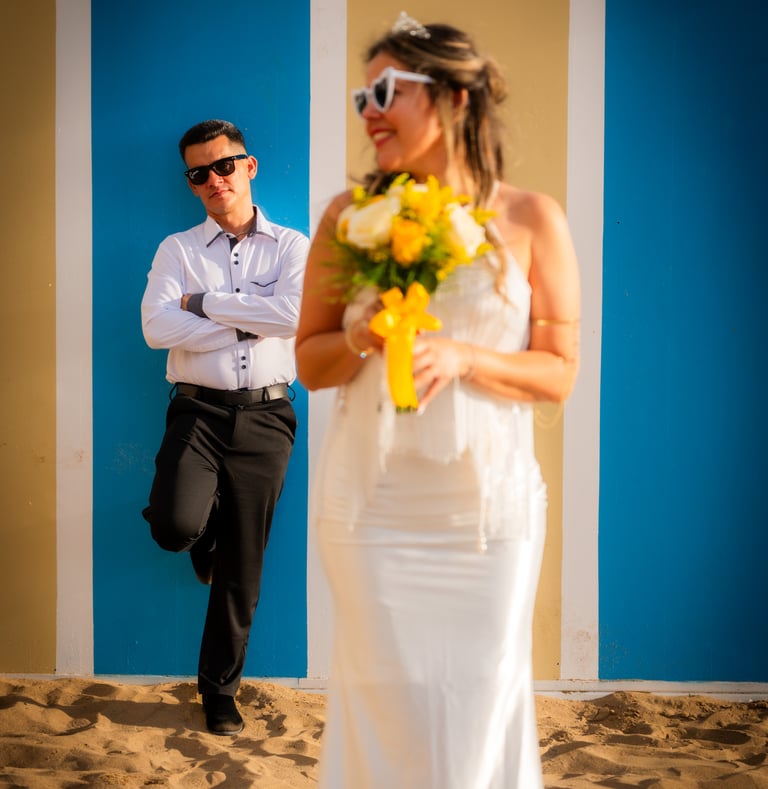 a man and woman in white wedding dress and sunglasses