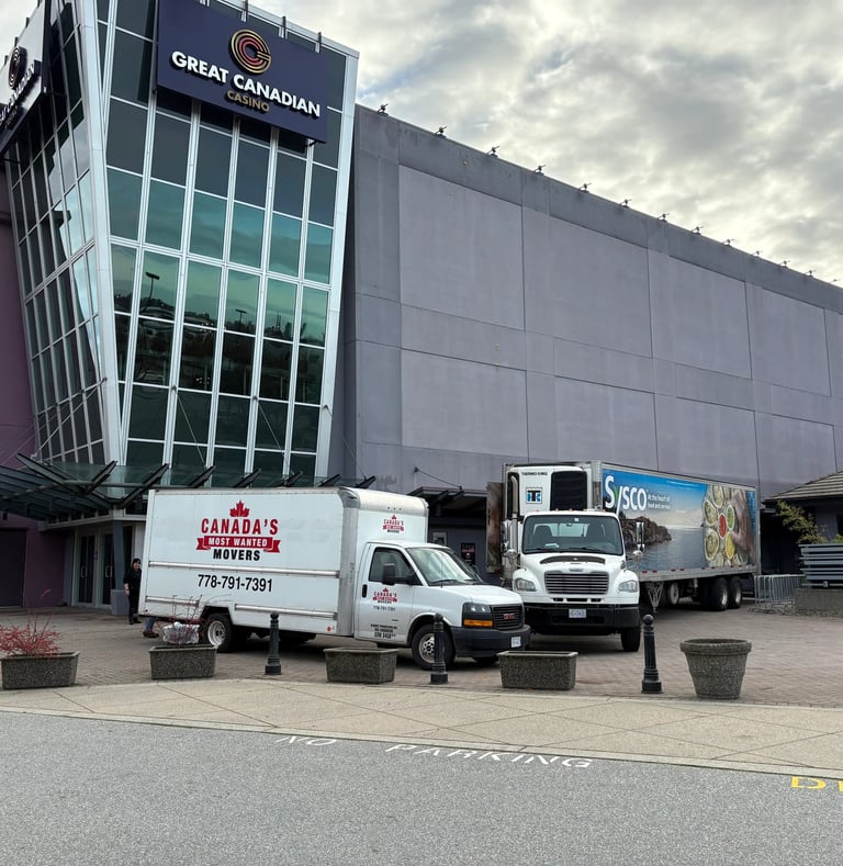 Canada’s Most Wanted Movers trucks parked at Great Canadian Casino Vancouver for a commercial moving job.