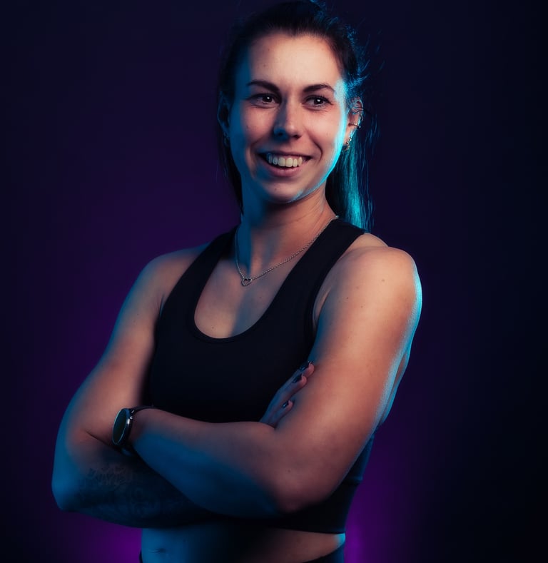 portrait photo of a woman in a black top and a purple background