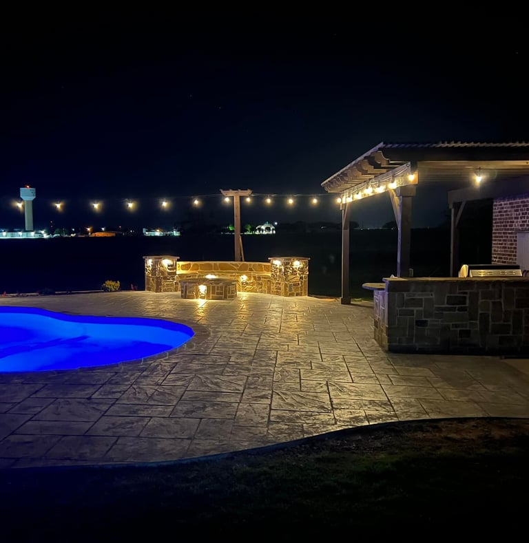 Outdoor Living Space at Night with Pool