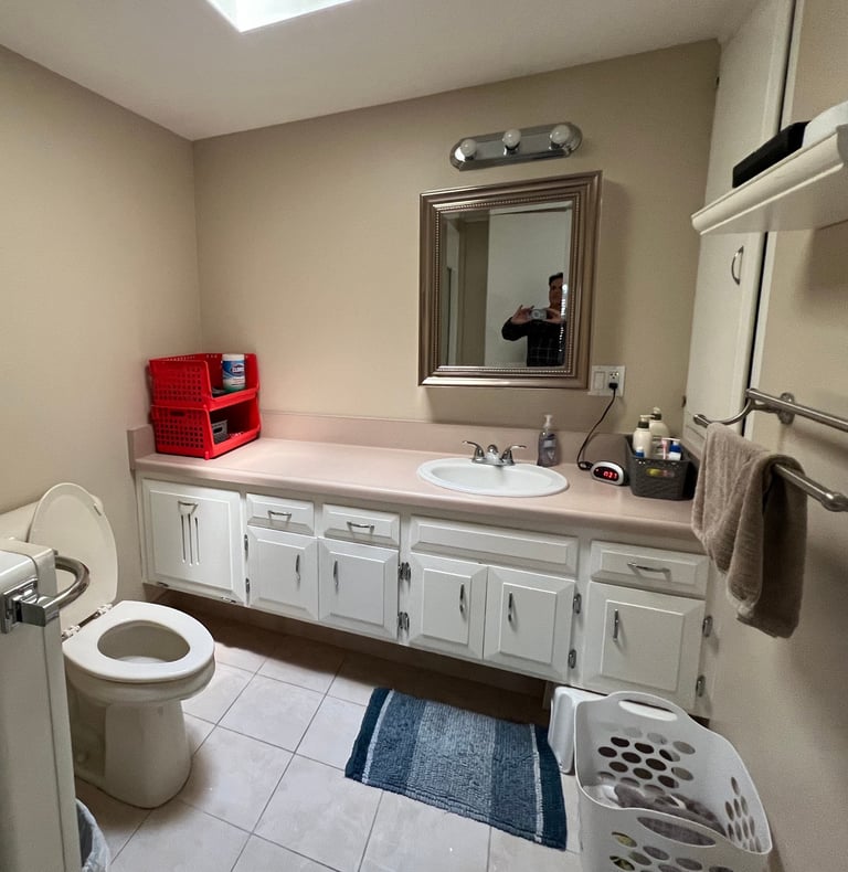 Before: a bathroom with a sink, toilet, and a toilet paper towel