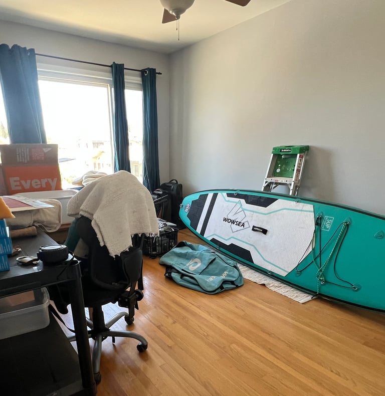 Before staging: clutered bedroom: with surfboarder's