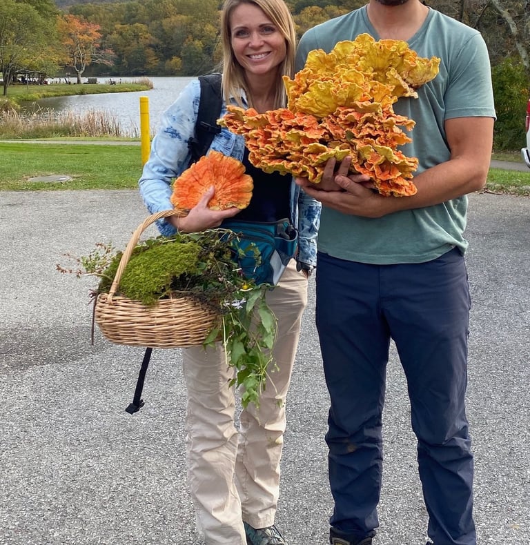 Owners 2123 rivermont holding mushrooms and a basket of mushrooms