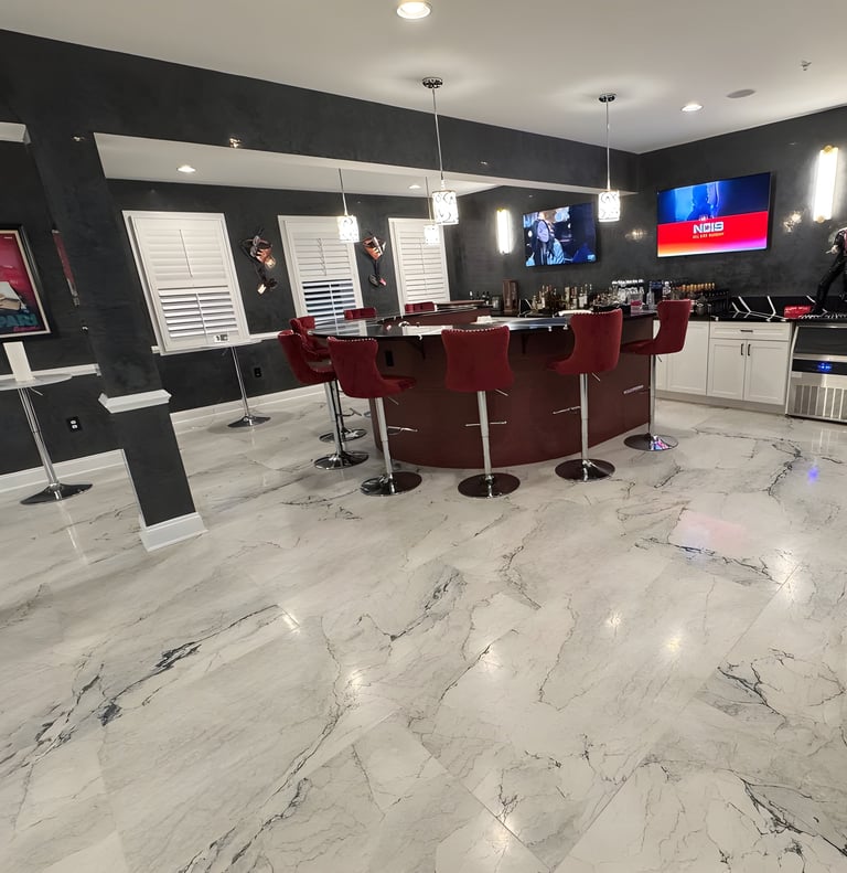 After image, a refreshed space featuring modern flooring, updated paint, and a custom bar setup.