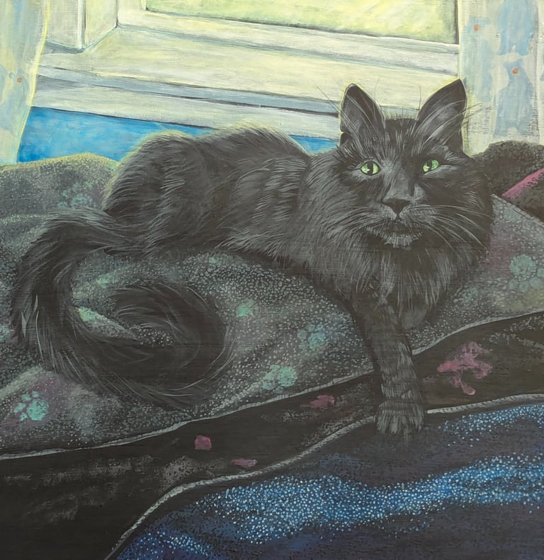 Framed painted portrait of a black long hair cat lounging in front of his window on his bed of blankets.