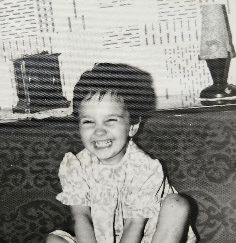 a toddler laughing towards the camera