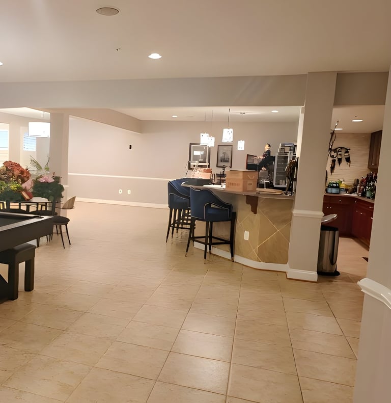 Before image of plain basement without charm - outdated flooring, bare walls, and minimal character