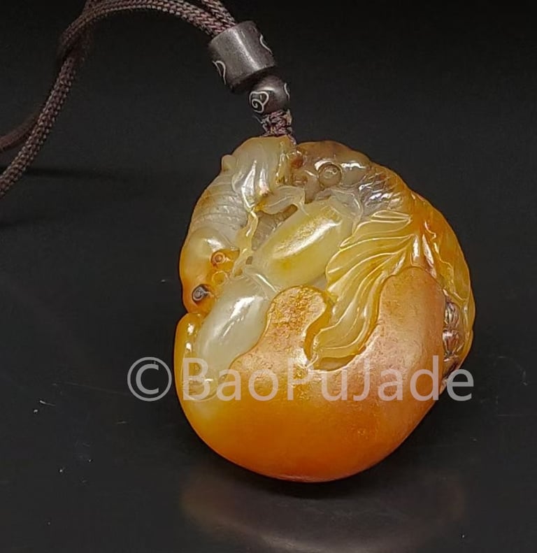 a yellow jade pendant with a dragon on it Hotan Jade