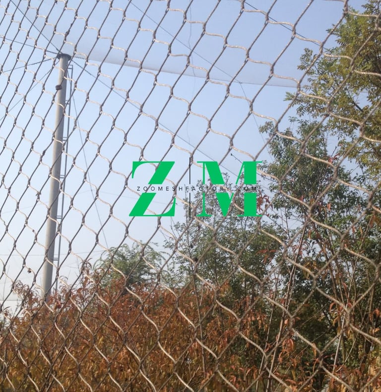 Durable stainless steel wire rope mesh used for zoo enclosure fencing in an outdoor park.