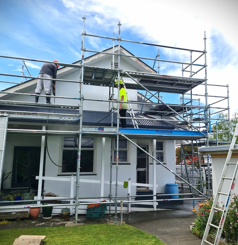 Gee Cee Painting team at work on scaffolding, restoring roof and exterior, with safety, care and precision.