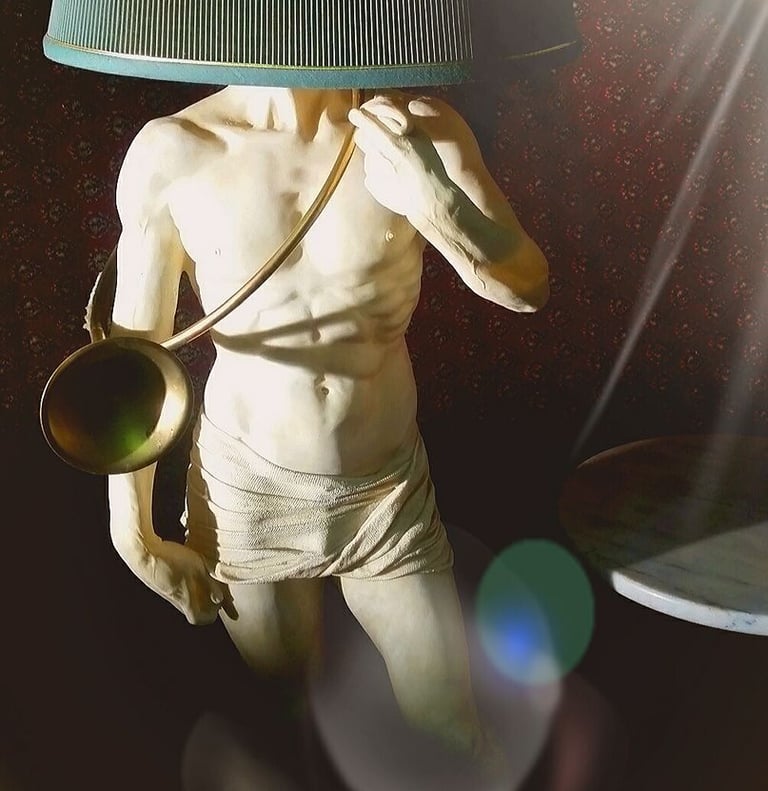a statue of a man with a lamp on a table