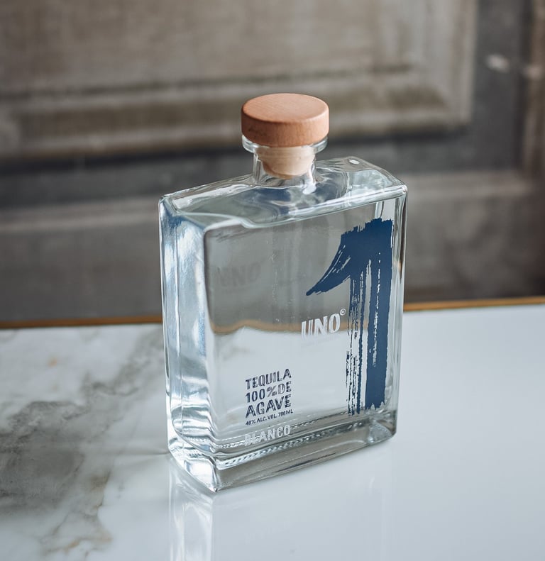 a bottle of Tequila Uno Blanco - premium tequila blanco