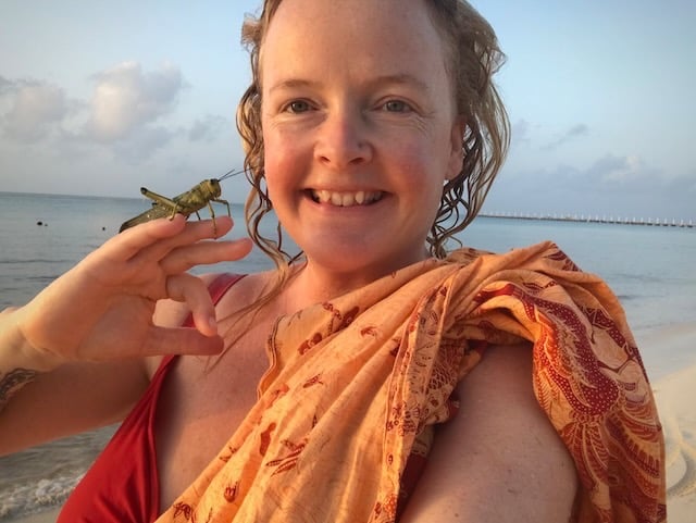 Sunni Dawson smiling with a cricket post rescue on beach