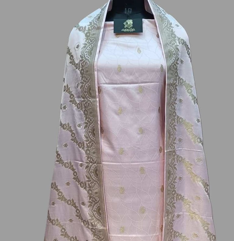 a pink and gold shawl - like shawl with a white and gold colored