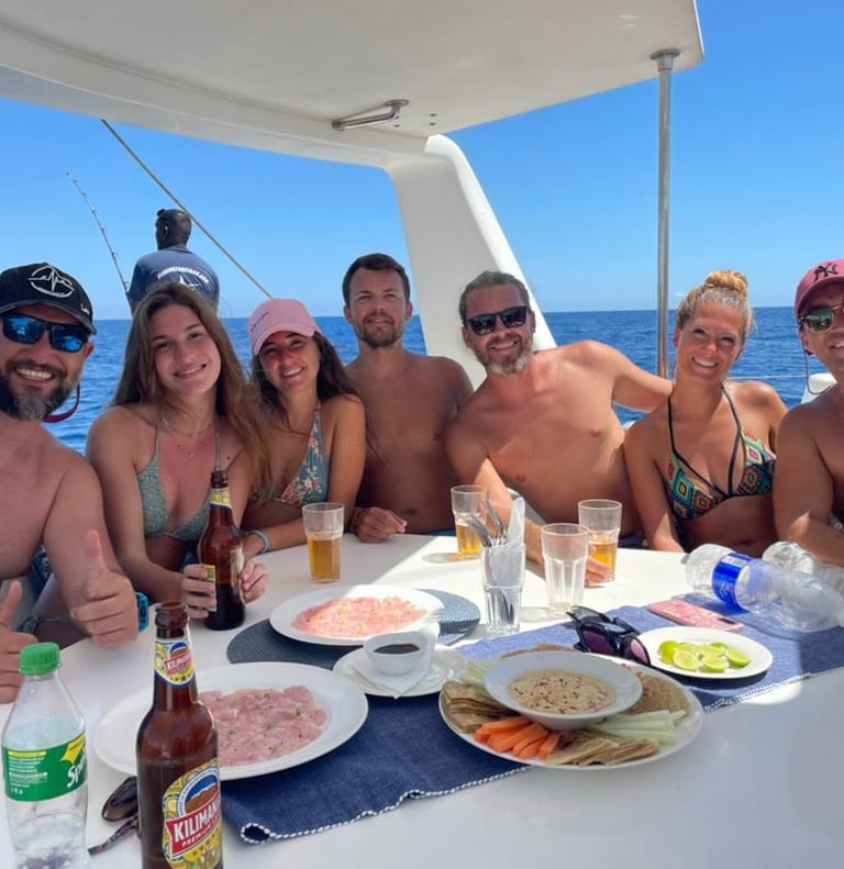 Happy family posing on a catamaran in the relaxation area - Catamaran Fishing Charters Seychelles