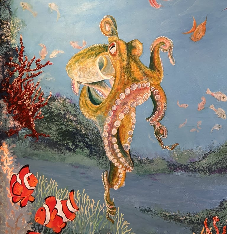 A bathroom wall mural featuring coral reef, clown fish, octopus, small fish and Anemone.
