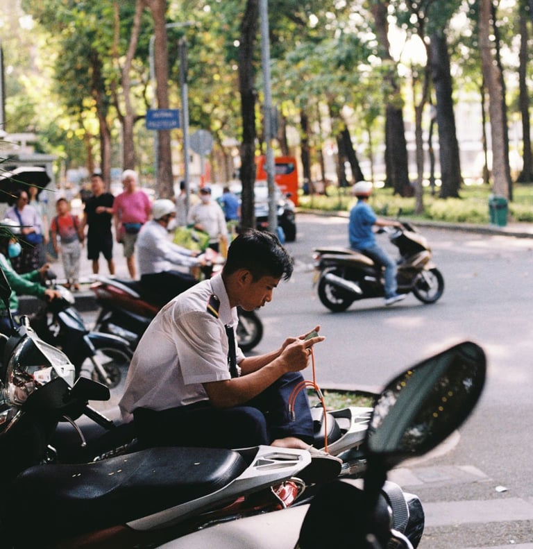 Vietnamese street security playing video game on the phone