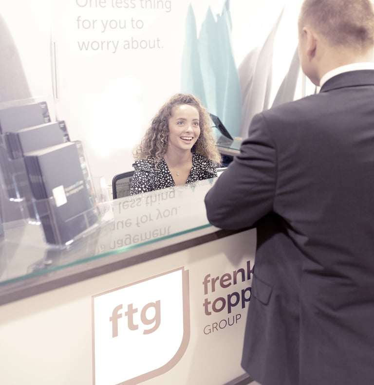a man and woman standing in front of a reception