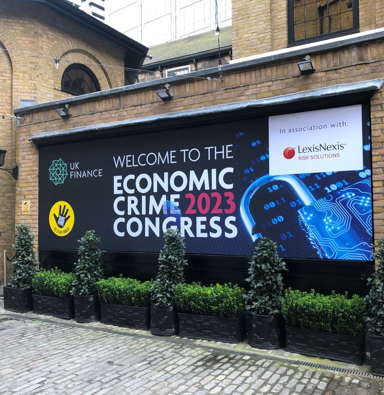 a photo of an outside banner with text reading welcome to the economic crime congress 2023