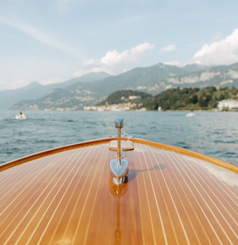 a boat on the water with a view of mountains in the background in lake como