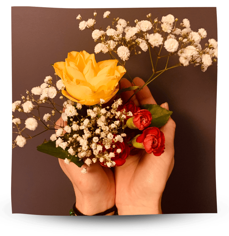 Holding flowers in hands.