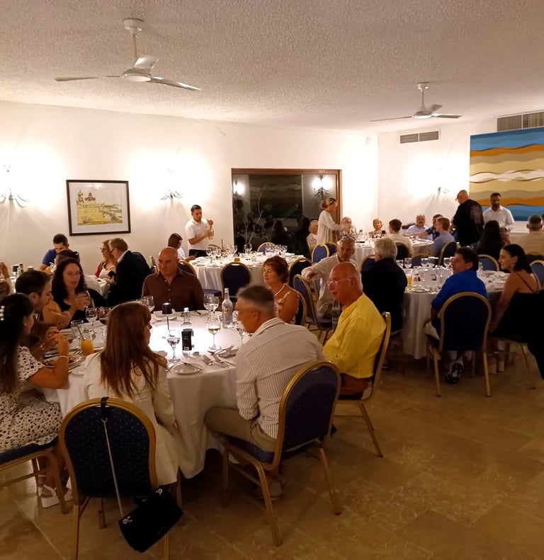 Guests enjoying a formal group dinner and banquet at an elegantly set restaurant event venue.