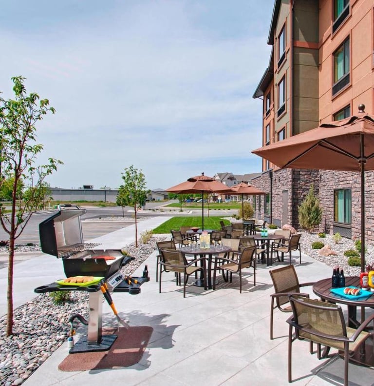 a patio with a grill and a grill