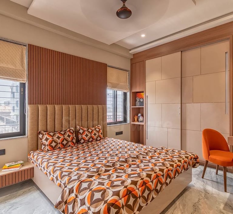a bedroom with a bed and a desk with a chair