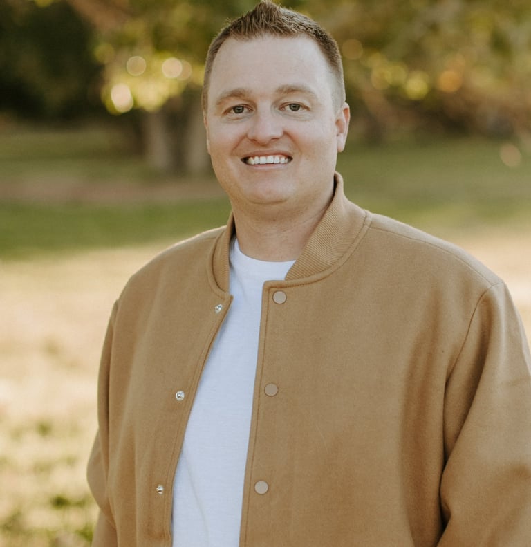 a man in a jacket and white shirt