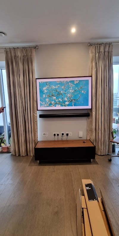 MountMyTV - Samsung Frame 55" TV & samsung soundbar mounted on a wall with cables concealed