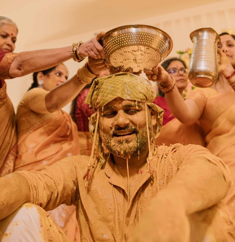 Bride smiling during vibrant Haldi ceremony captured by Mandap Pictures wedding photographers in India.