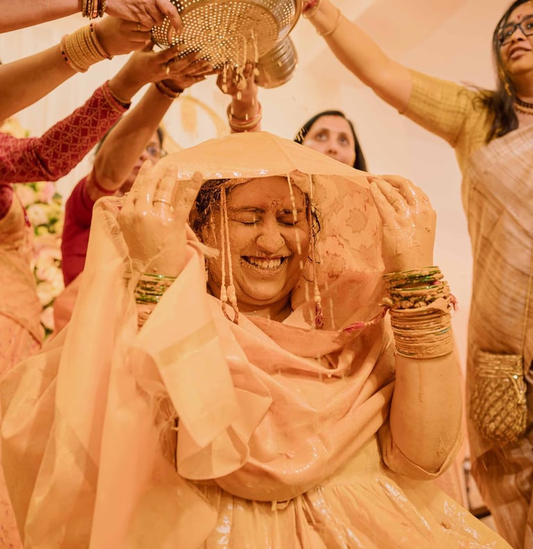 Bride smiling during vibrant Haldi ceremony captured by Mandap Pictures wedding photographers in Ind