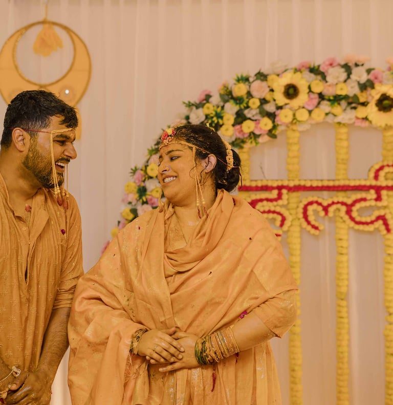 Bride smiling during vibrant Haldi ceremony captured by Mandap Pictures wedding photographers 